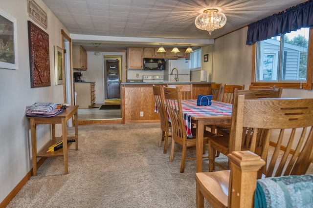 1352 Haughey Dr, Union City, MI 49094 - dining space with light carpet, a chandelier, and baseboards