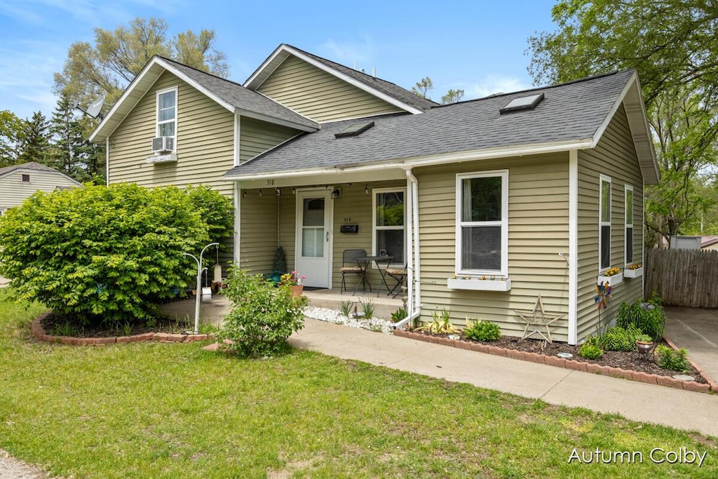 918 W Grove St, Greenville, MI 48838 - view of front of property featuring roof with shingles, covered porch, and cooling unit