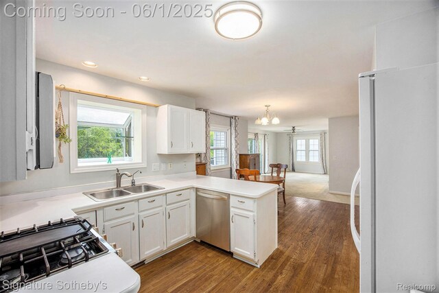 7674 Woodside Pl, Waterford, MI 48327 - kitchen featuring dishwasher, freestanding refrigerator, a sink, a chandelier, and dark wood-style floors