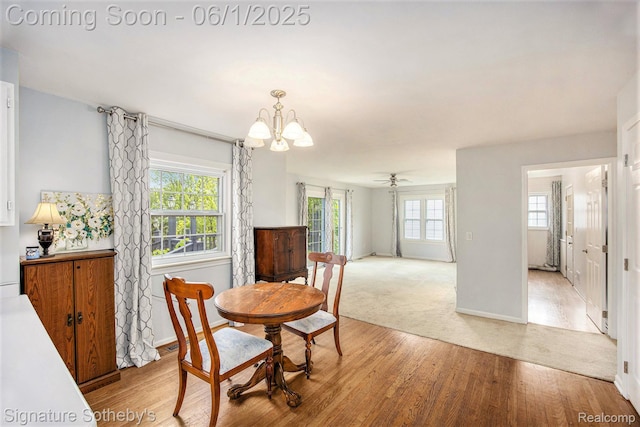 7674 Woodside Pl, Waterford, MI 48327 - dining space with a chandelier, light wood finished floors, baseboards, and light colored carpet