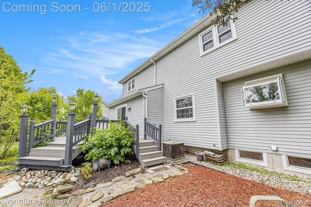 7674 Woodside Pl, Waterford, MI 48327 - back of house featuring central AC and a deck
