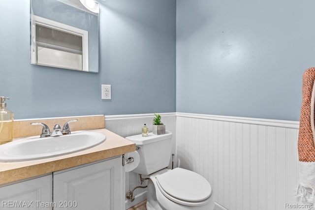 7485 Pointe Dr, Canton, MI 48187 - bathroom featuring a wainscoted wall, toilet, and vanity