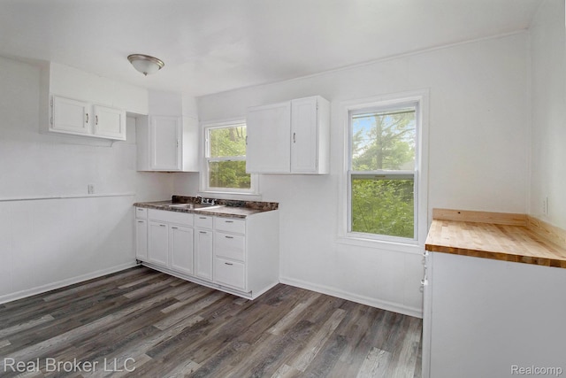 19455 Houghton St, Detroit, MI 48219 - kitchen with dark wood finished floors, white cabinetry, a sink, baseboards, and butcher block countertops