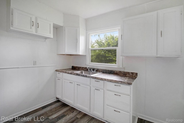 19455 Houghton St, Detroit, MI 48219 - kitchen featuring dark countertops, dark wood-style floors, a sink, white cabinetry, and baseboards