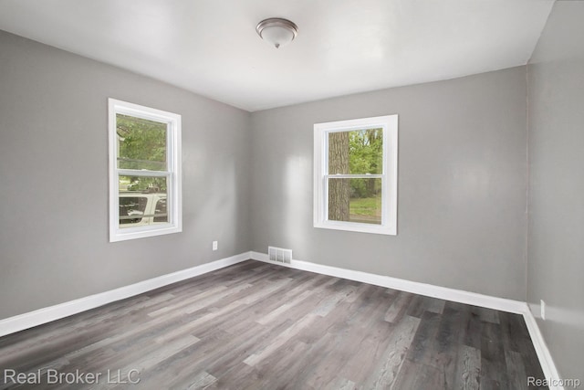 19455 Houghton St, Detroit, MI 48219 - unfurnished room featuring healthy amount of natural light, baseboards, and dark wood finished floors