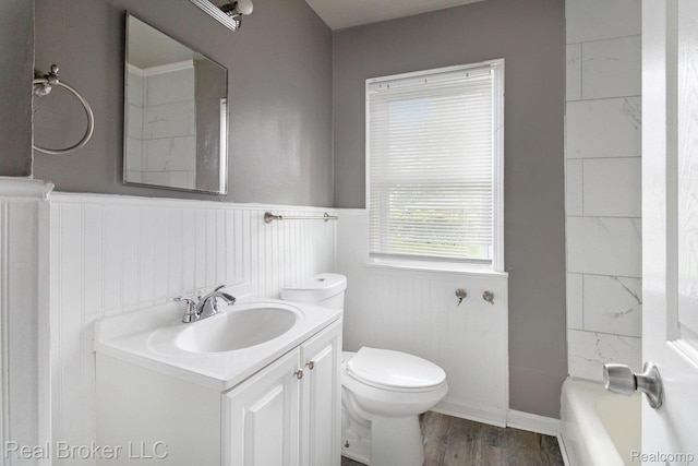 19455 Houghton St, Detroit, MI 48219 - bathroom featuring vanity, wainscoting, a bath, toilet, and wood finished floors