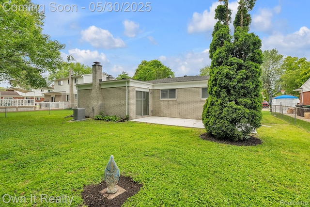10419 Michael St, Dearborn, MI 48180 - back of property with cooling unit, a patio, brick siding, and a chimney