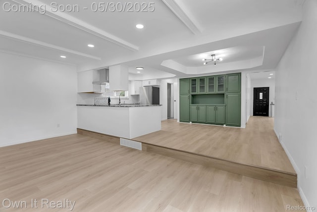 10419 Michael St, Dearborn, MI 48180 - unfurnished living room with light wood-style floors, baseboards, recessed lighting, beam ceiling, and a raised ceiling