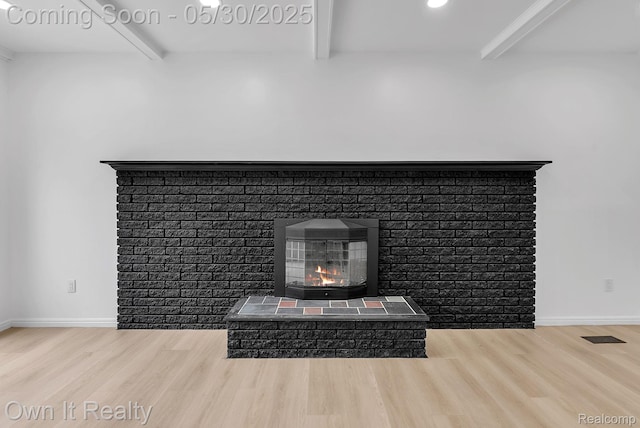 10419 Michael St, Dearborn, MI 48180 - detailed view of beamed ceiling, wood finished floors, a brick fireplace, baseboards, and recessed lighting