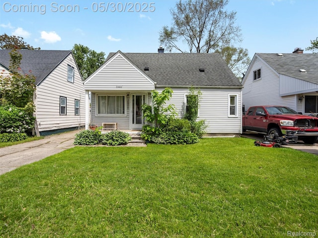 26066 Dartmouth St, Royal Oak, MI 48071 - view of front of house featuring a front lawn, a shingled roof, and a chimney