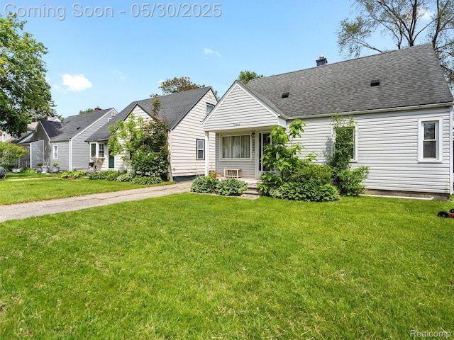 26066 Dartmouth St, Royal Oak, MI 48071 - view of front facade with a front lawn, a chimney, and roof with shingles