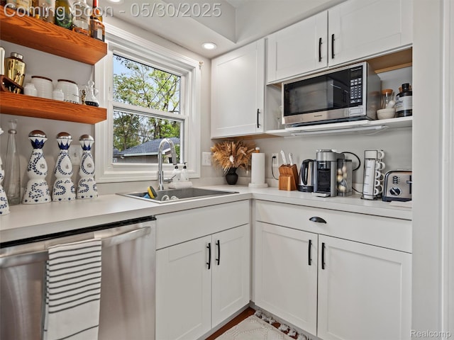 26066 Dartmouth St, Royal Oak, MI 48071 - kitchen featuring stainless steel appliances, open shelves, a sink, light countertops, and white cabinets