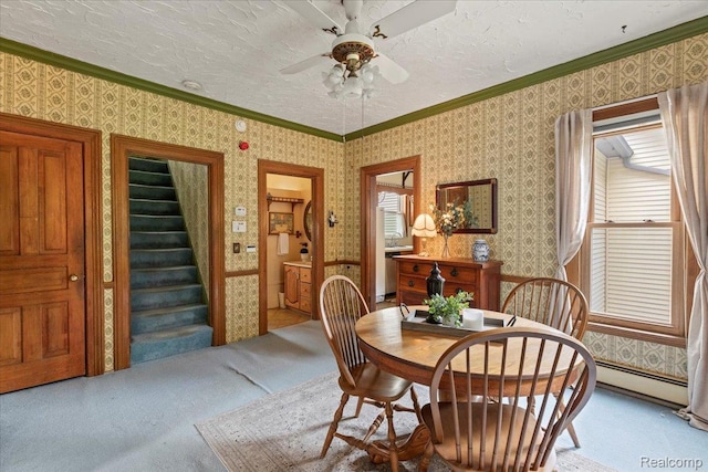 91 Dennison St, Oxford, MI 48371 - dining area with a baseboard heating unit, carpet floors, ceiling fan, crown molding, and stairs