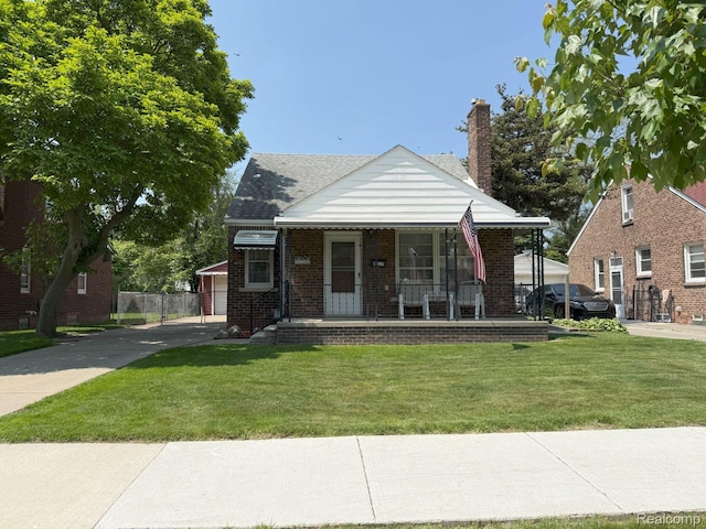 4017 Woodworth St, Dearborn, MI 48126 - bungalow-style house with covered porch, a front yard, brick siding, and a chimney