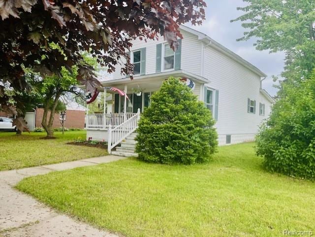 203 S Main St, Capac, MI 48014 - view of front of property with covered porch and a front yard