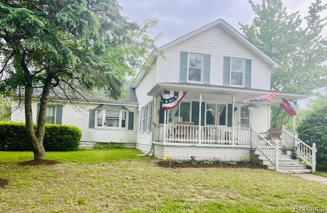 203 S Main St, Capac, MI 48014 - view of front of property with a porch and a front lawn
