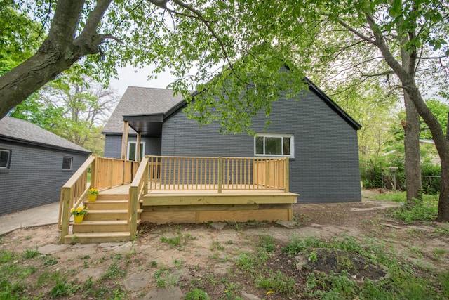 1658 Joslyn Rd, Muskegon, MI 49445 - back of house with brick siding and a wooden deck