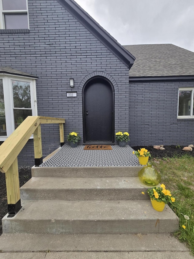 1658 Joslyn Rd, Muskegon, MI 49445 - view of exterior entry with brick siding and a shingled roof