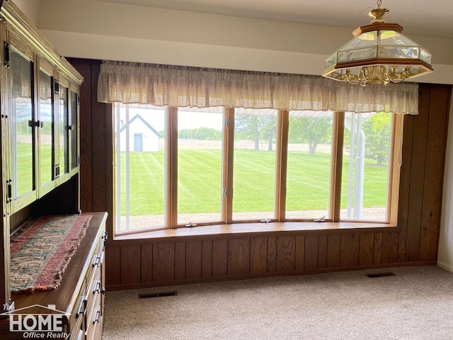 2437 S State Rd, Corunna, MI 48817 - sunroom / solarium featuring plenty of natural light, carpet floors, wood walls, and french doors