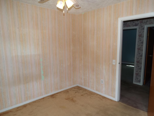 407 Doty St, Leslie, MI 49251 - carpeted spare room featuring wallpapered walls, a ceiling fan, baseboards, a baseboard heating unit, and a textured ceiling