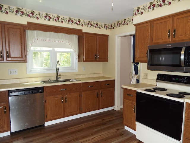 407 Doty St, Leslie, MI 49251 - kitchen featuring stainless steel appliances, a sink, light countertops, and brown cabinets