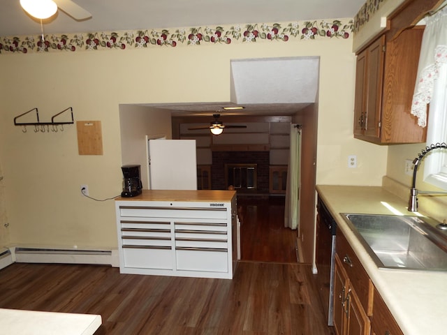 407 Doty St, Leslie, MI 49251 - kitchen featuring ceiling fan, a sink, dark wood-style flooring, brown cabinets, and dishwashing machine