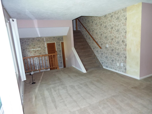 407 Doty St, Leslie, MI 49251 - unfurnished living room with wallpapered walls, carpet, baseboards, and a textured ceiling
