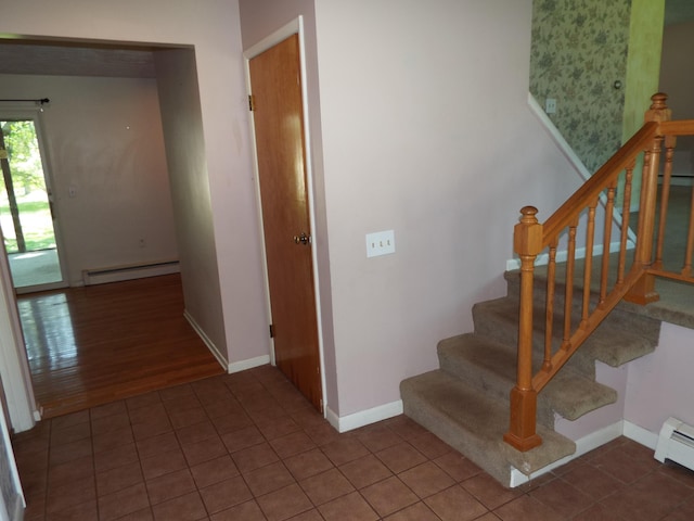 407 Doty St, Leslie, MI 49251 - stairs with a baseboard heating unit, baseboards, and tile patterned floors