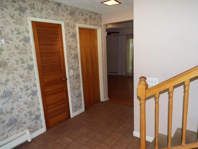 407 Doty St, Leslie, MI 49251 - corridor with a baseboard heating unit, wallpapered walls, baseboards, and tile patterned floors