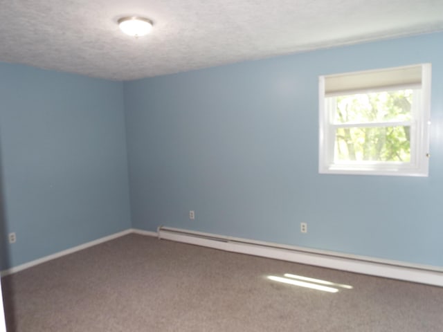 407 Doty St, Leslie, MI 49251 - unfurnished room featuring carpet, a baseboard radiator, a textured ceiling, and baseboards