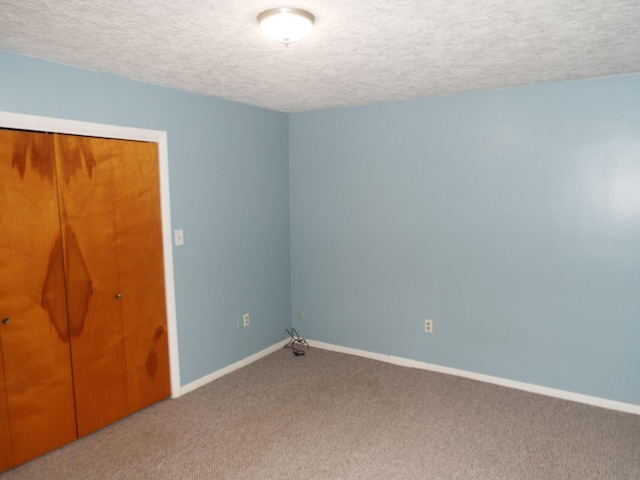 407 Doty St, Leslie, MI 49251 - unfurnished bedroom with carpet flooring, a textured ceiling, baseboards, and a closet