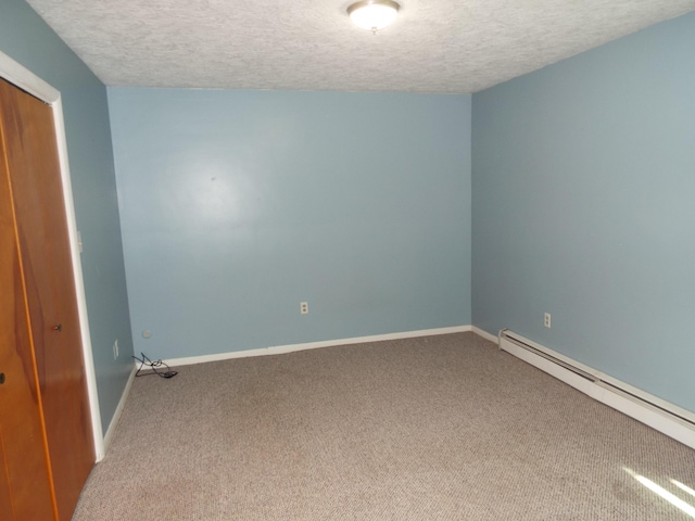407 Doty St, Leslie, MI 49251 - unfurnished bedroom with carpet, a baseboard radiator, a textured ceiling, baseboards, and a closet