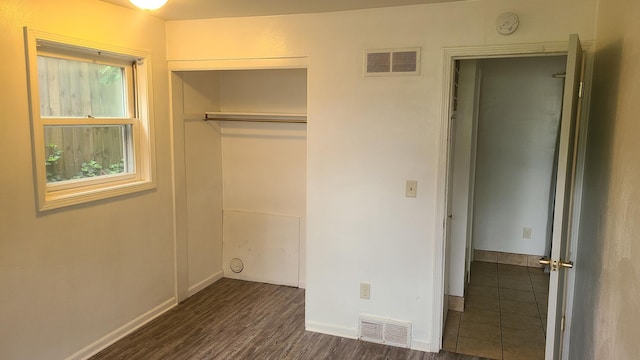 1828-1830 Winton, Kalamazoo, MI 49001 - unfurnished bedroom featuring dark wood-style floors, a closet, and baseboards