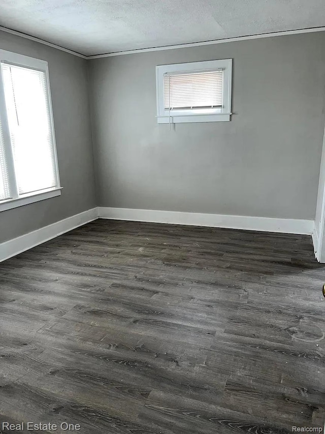 2332 Clements St, Detroit, MI 48238 - empty room with dark wood-type flooring, baseboards, ornamental molding, and a textured ceiling