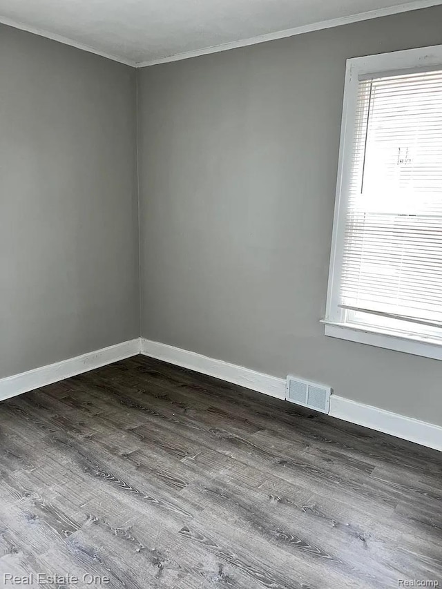 2332 Clements St, Detroit, MI 48238 - empty room with ornamental molding, plenty of natural light, baseboards, and dark wood-type flooring