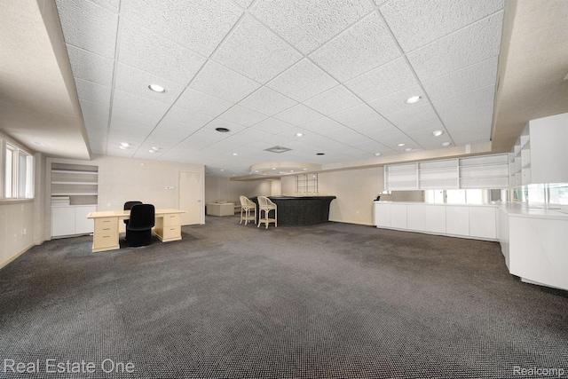 4017 Hidden Woods, Bloomfield Hills, MI 48301 - unfurnished living room with a desk, dark carpet, recessed lighting, and a drop ceiling