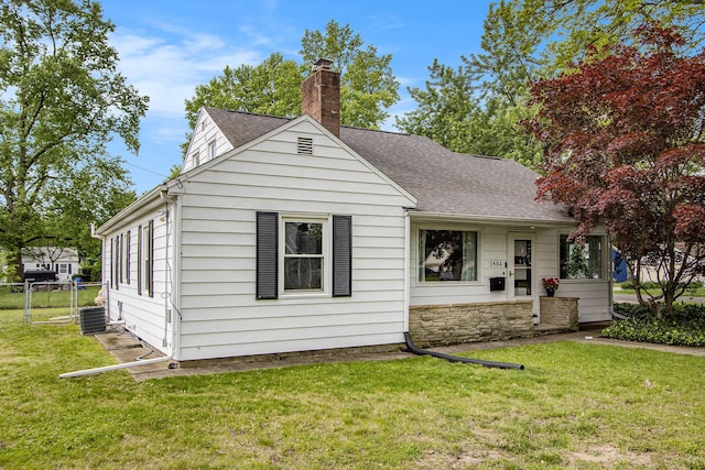 1804 Lakeway Ave, Kalamazoo, MI 49001 - view of front of property with a chimney, roof with shingles, central AC, and stone siding