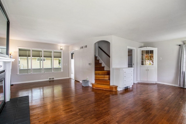 1804 Lakeway Ave, Kalamazoo, MI 49001 - unfurnished living room with a glass covered fireplace, wood finished floors, and baseboards