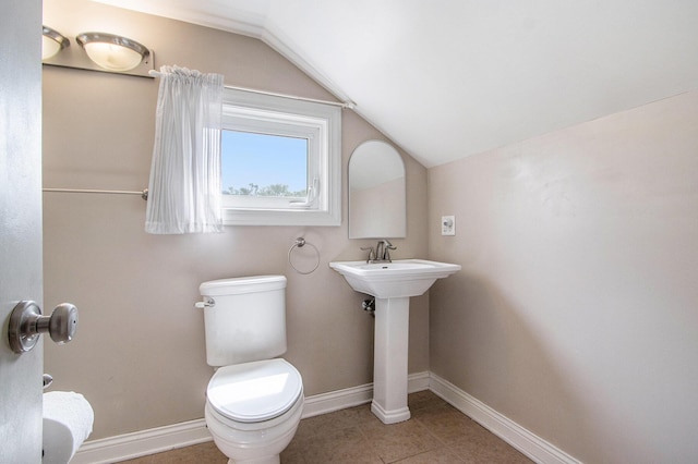 1804 Lakeway Ave, Kalamazoo, MI 49001 - bathroom with lofted ceiling, toilet, baseboards, tile patterned flooring, and a sink