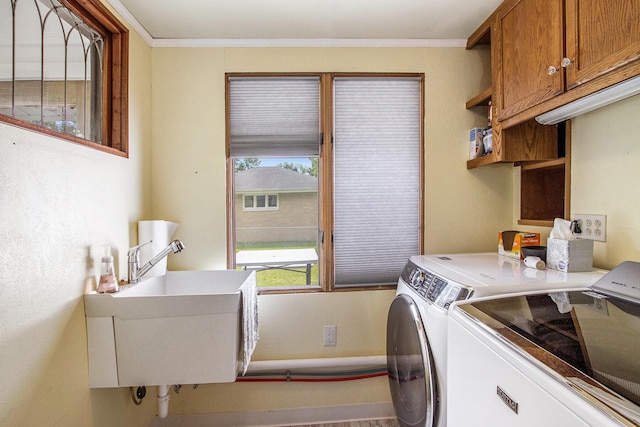 1804 Lakeway Ave, Kalamazoo, MI 49001 - laundry room with washing machine and dryer, cabinet space, and ornamental molding