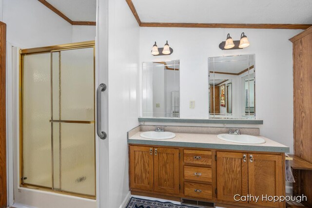 3079 E Bluewater Hwy, Ionia, MI 48846 - full bathroom with crown molding, a shower stall, and double vanity