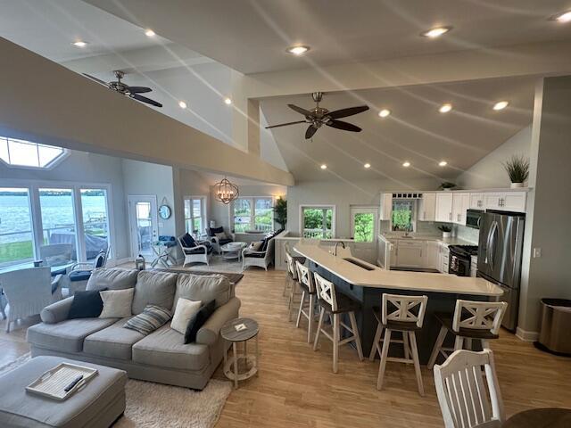 9393 Fraulin Dr, Richland, MI 49083 - living area with a ceiling fan, high vaulted ceiling, light wood-style floors, and recessed lighting