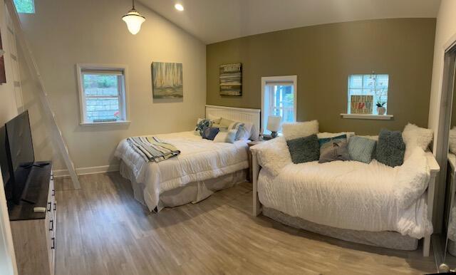 9393 Fraulin Dr, Richland, MI 49083 - bedroom with vaulted ceiling, multiple windows, wood finished floors, baseboards, and recessed lighting