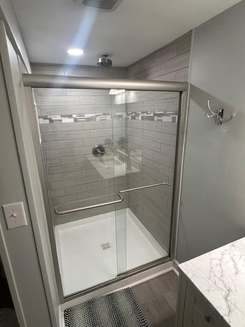 9393 Fraulin Dr, Richland, MI 49083 - bathroom with a shower stall, wood finished floors, and vanity