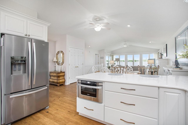 714 N Hawley Dr, Coldwater, MI 49036 - kitchen featuring stainless steel appliances, ceiling fan, vaulted ceiling, white cabinetry, and light countertops