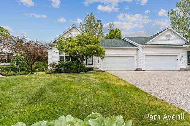 15011 Saddlebrook Trl, Spring Lake, MI 49456 - view of front of house featuring asphalt driveway, a garage, and a front lawn