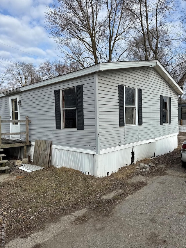 2445 E Grand River Rd, Lot, Williamston, MI 48895 - view of side of property featuring a wooden deck