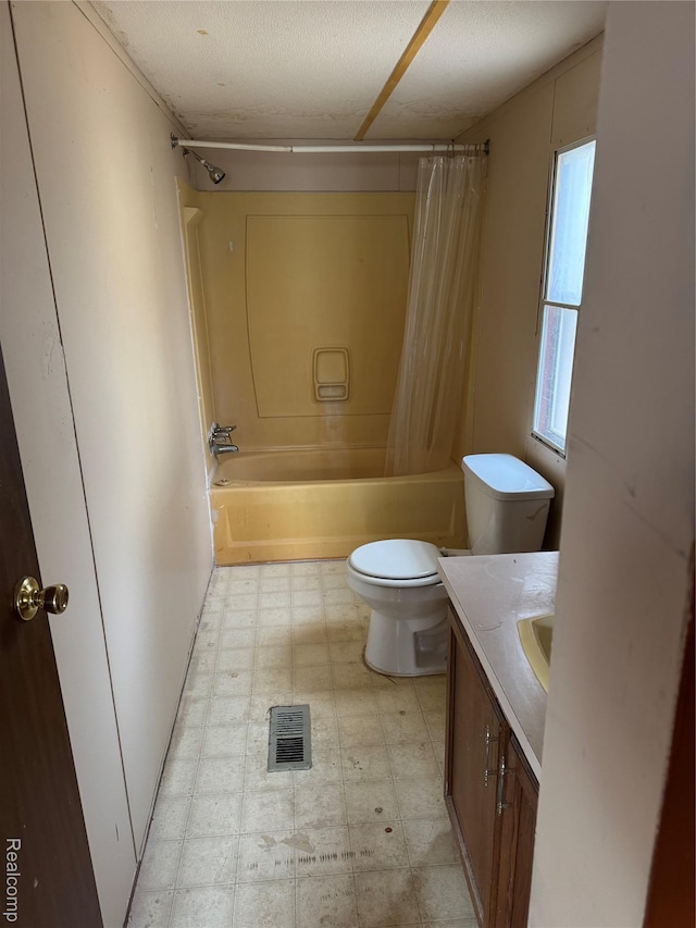 2445 E Grand River Rd, Lot, Williamston, MI 48895 - full bathroom featuring tile patterned floors, toilet, vanity, and shower / tub combo with curtain