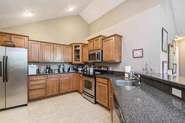 933 Bridge Crest Dr SE, Ada, MI 49301 - kitchen featuring appliances with stainless steel finishes, a sink, brown cabinetry, high vaulted ceiling, and light tile patterned floors