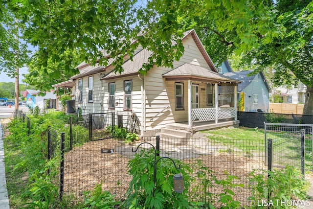 1000 Garfield Ave NW, Grand Rapids, MI 49504 - view of front of house featuring a shingled roof, a fenced backyard, and a gate